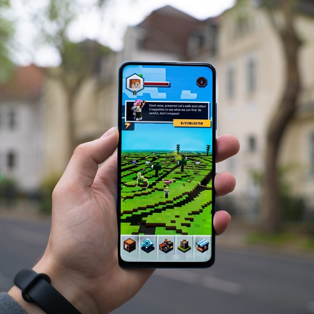 hand holding a phone showing a video game
