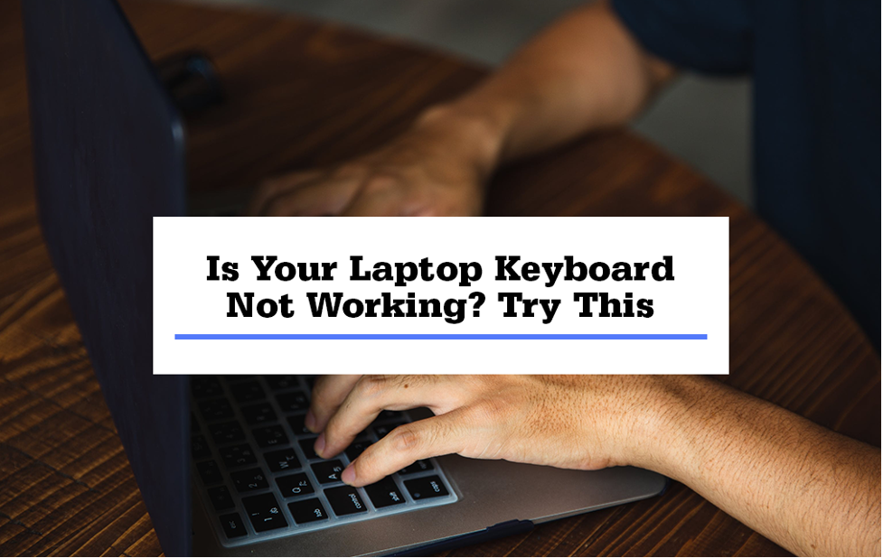 man typing on laptop keyboard